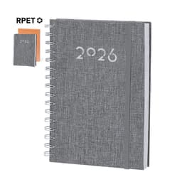 A grey spiral-bound diary with the year "2026" printed on the cover, accompanied by a smaller notebook in orange.