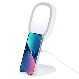 A wireless charger in white with a mirror design, featuring a phone supported upright for charging.