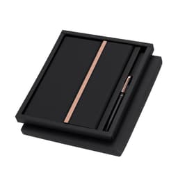 A black gift set featuring a sleek notebook with a rose gold band and a matching pen, presented in a black box.