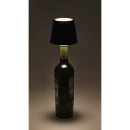 A stylish lamp featuring a black shade atop a green glass bottle, creating a unique decorative piece.