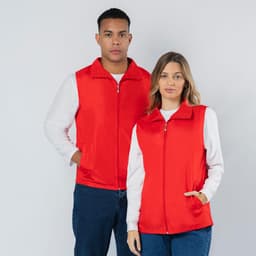 A red vest jacket featuring a zip closure and side pockets, modelled by a man and a woman. The jacket has a logo.