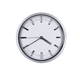 A wall clock featuring a round silver frame, white face, and black hour and minute hands.