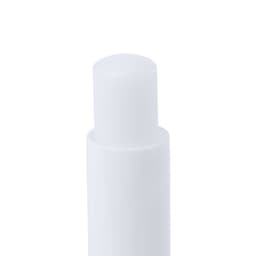 A lip balm in a cylindrical white tube with a smooth top and a simple logo.