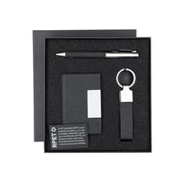 A gift set containing a black pen, a keyring, and a notebook, all presented in a black box with a logo.