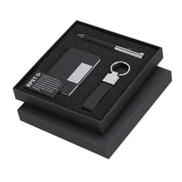 A gift set featuring a black cardholder, keyring, and pen, all presented in a sleek black box.
