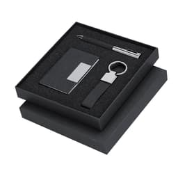 A black gift set containing a pen, keyring, and business card holder, presented in a stylish box.