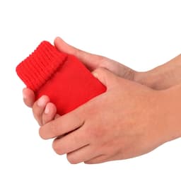 A red fabric item held in two hands, featuring a ribbed cuff at one end.