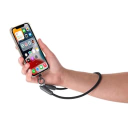 A black charging cable is attached to a smartphone held in a hand, featuring a loop for secure holding.