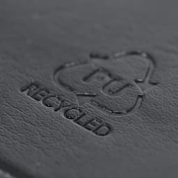 A black notebook featuring a recycled logo embossed on the cover, indicating its eco-friendly materials.