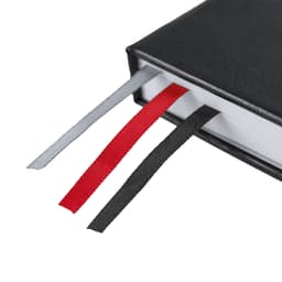 A black Suran Notebook featuring three ribbon bookmarks in grey, red, and black. It has a simple, elegant design.