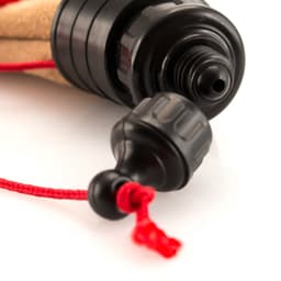 A drink bottle with a black lid and cork body, featuring a red cord. Designed for outdoor leisure activities.