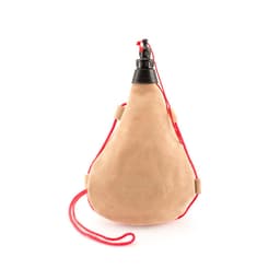A drink bottle in a tan suede finish with a black nozzle and red cord for easy carrying.
