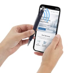 A metal pen in a hand, held alongside a smartphone displaying a webpage, showcasing a sleek design in blue.