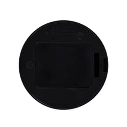 A circular black device with a small slot and a logo, likely a technology accessory.