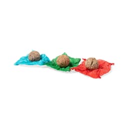 Three seed balls in earthy tones, placed on blue, green, and red crinkled wrappers.