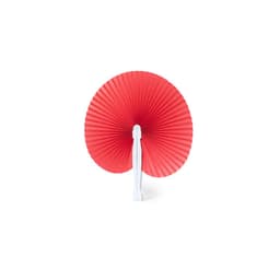 A red hand fan with a white handle, showcasing a pleated design. The fan is closed and displays a circular shape.