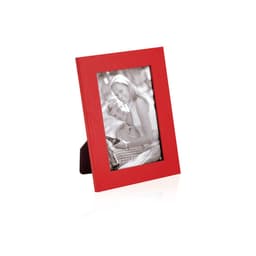 A red photo frame displaying a black and white image of a couple. The frame has a stand for tabletop display.