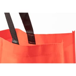 A bright red tote bag with black handles, featuring a simple design and a logo.