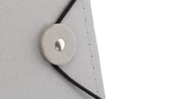 A grey Vimaz Folder with a button closure and a black elastic band. It features a simple, minimalist design.