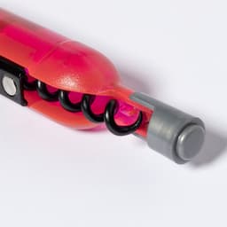 A pink and grey corkscrew with a spiral design, featuring a black corkscrew mechanism and a grey end cap.