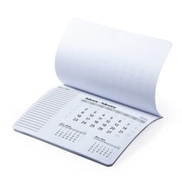 A desk calendar mousepad in white with monthly calendar pages and lined notes sections. It has a simple design.