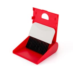 A red cleaning set featuring a small dustpan with a white handle and black bristles for sweeping.