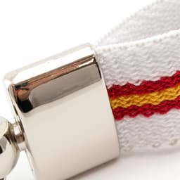 A keyring featuring a silver metal clasp and a white strap with red and yellow stripes.