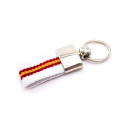 A keyring featuring a white strap with red and yellow stripes and a metallic attachment.