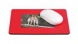 A red mousepad featuring a photo frame and a white computer mouse on top of it.