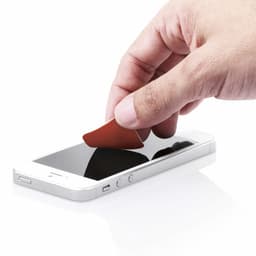 A hand holds a red cleaning cloth, gently wiping a smartphone screen on a white surface.