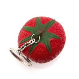 A red strawberry-shaped keyring with green detailing, attached to a silver keychain.