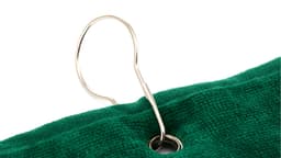 A green golf towel featuring a metal loop for hanging. The fabric appears soft and absorbent.