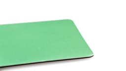 A green magnet with a smooth surface, featuring rounded corners and a subtle sheen.