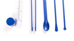 A blue cocktail set featuring a measuring cup, stirring sticks, and a mixing spoon, all in vibrant blue.