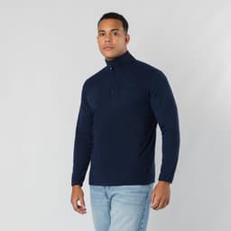 A polar fleece jacket in navy blue on a model, featuring a half-zip collar and long sleeves.