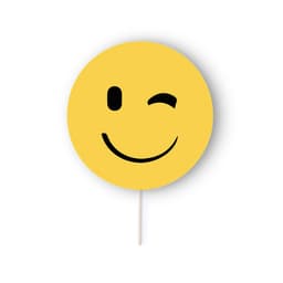 A yellow round sign with a black smiling face and wink, featuring a wooden stick for support.