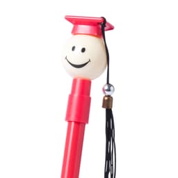 A red pen with a smiling, graduation-cap topped design, featuring a tassel and a small decorative bead.