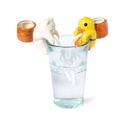 A glass with water and two playful straws, one shaped like a cat and the other like a duck.