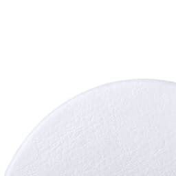A close-up of a textured white surface, resembling leather, with a smooth, round edge. It includes a logo in the corner.