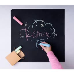 A chalkboard with "Remix" written in colourful chalks, accompanied by a small box of pastel chalks.