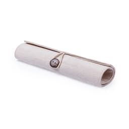 A beige pencil case made of fabric, rolled up and secured with a button closure. It features a logo.