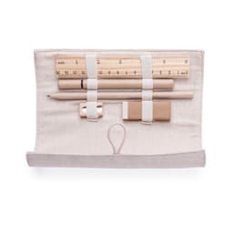 A pencil case in beige, containing pencils, a ruler, an eraser, and a sharpener, secured with elastic straps.