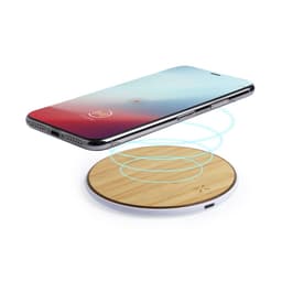 A wireless charger with a circular wooden base and a smartphone positioned above it, showcasing wireless charging technology.
