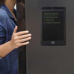 A black magnetic writing board attached to a refrigerator, featuring a list of tasks.