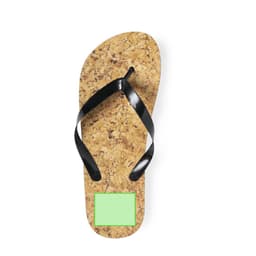 A cork flip flop with black straps and a square green panel on the sole, featuring a logo.