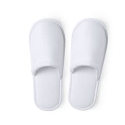 A pair of white, soft slippers with an open toe design, featuring a cushioned footbed and a simple, minimalist style.