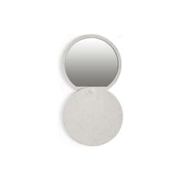 A circular compact mirror with a light grey textured casing. The mirror has a simple design and features a logo.