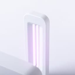 A wireless charger in white featuring two vertical purple charging lights. It has a sleek, modern design and a branding logo.
