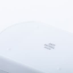 A white antibacterial pillbox featuring a smooth surface and small raised dots for grip. It has a logo.