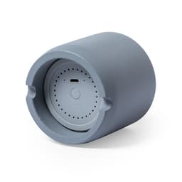 A grey Bluetooth speaker with a rounded design and a textured surface, featuring a small control panel.